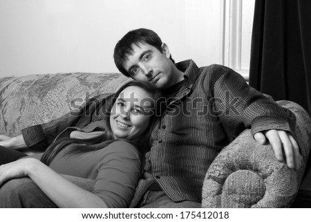 Similar – Joyful couple laughing together on a vintage sofa