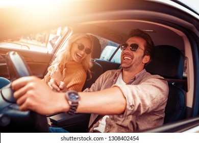 Happy Young Couple Enjoying On A Long Drive In A Car.