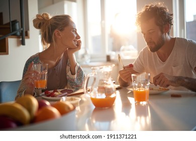 A happy young couple enjoying wonderful moments on a beautiful sunny morning while having a breakfast together. Relationship, love, together, breakfast - Powered by Shutterstock