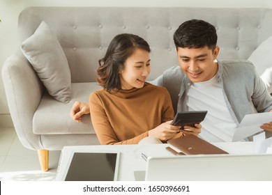 Happy young couple excited by reading good news in paper letter about refund tax money,