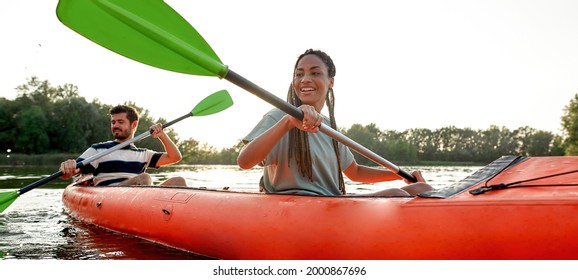 Happy Young Couple Of Friends Having Fun On Kayak On A Late Summer Afternoon. Kayaking, Travel, Leisure Concept. Web Banner