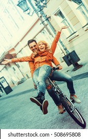 Happy young couple going for a bike ride on a autumn day in the city. - Shutterstock ID 508695808