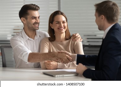 Happy Young Couple Handshake Lawyer Insurer Broker Make Financial Business Deal, Smiling Satisfied Family Shake Hand Of Realtor Insurer Thanking For Consulting Buying Insurance Services At Meeting