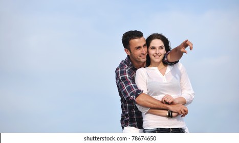 Happy Young Couple Have Fun And Romantic Moments On Beach At Summer Season And Representing Happiness And Travel Concept