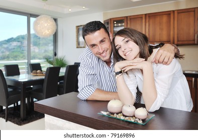 happy young couple have fun in modern wooden  kitchen indoor while preparing fresh food - Powered by Shutterstock