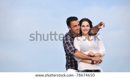 happy young couple have fun and romantic moments on beach at summer season and representing happiness and travel concept