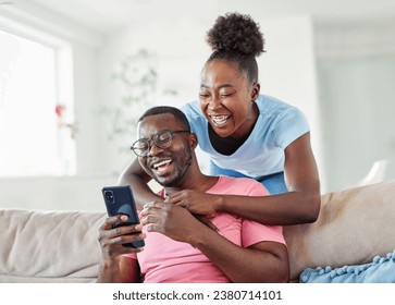 Happy young couple having fun using smartphone  during oline video call conversation or shopping or using an app at home - Powered by Shutterstock