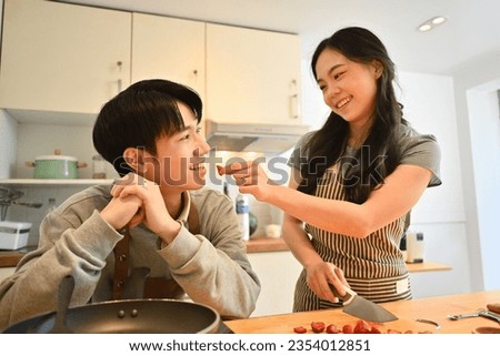 Similar – Image, Stock Photo Romantic moment with a couple sharing a strawberry on a rooftop