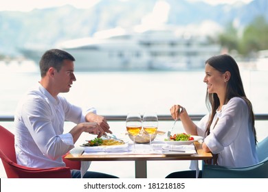 Happy Young Couple Having Lanch At Beautiful Restaurant On The Beach