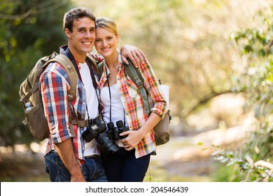 Happy Young Couple Hiking In Mountain