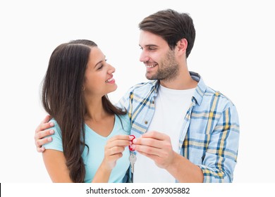 Happy Young Couple Holding New House Key On White Background