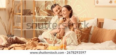 Happy young couple hugging while sitting in bedroom. Love compatibility horoscope. Partner matching by date of birth 