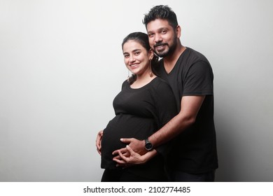 Happy Young Couple Of Indian Ethnicity Expecting A Baby Standing Together