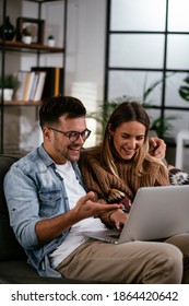 Happy Young Couple With Laptop At Home	