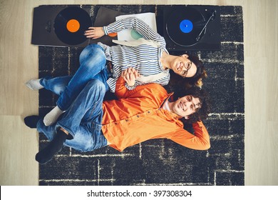 Happy Young Couple Listening To Music - Vinyl. Bird Eye View.