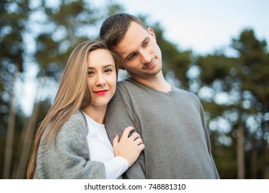 Happy young couple in love hugging. Park outdoors date. Loving couple looking at camera portrait. - Shutterstock ID 748881310