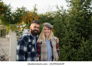 Happy young couple in love smiling and spending time together. Bearded man and beautiful blonde woman walking at fall autumnal park. Hipster couple enjoy autumn nature. - Powered by Shutterstock