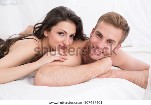 Happy Young Couple Lying White Bed Stock Photo Edit Now 307489601