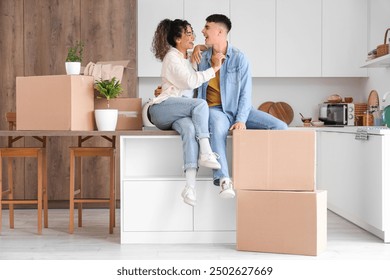 Happy young couple with moving boxes at new home - Powered by Shutterstock