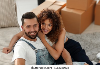 Happy young couple in a new apartment. - Shutterstock ID 1063350638