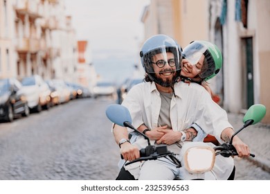 Happy young couple in protective hats are riding on vintage scooter in the Lisbon street - Powered by Shutterstock