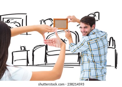 Happy Young Couple Putting Up Picture Frame Against Living Room Sketch