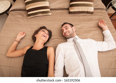 Happy Young Couple Relaxing In Hotel Room. 