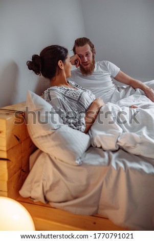 Similar – Image, Stock Photo Man showing baby clothes to pregnant woman