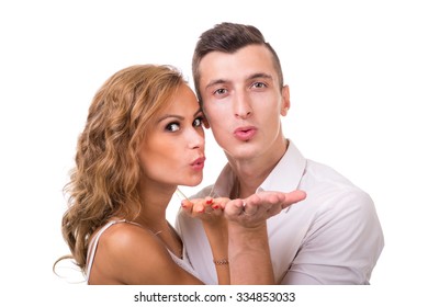 Happy young couple sending a blow kiss to the camera against isolated white background - Powered by Shutterstock