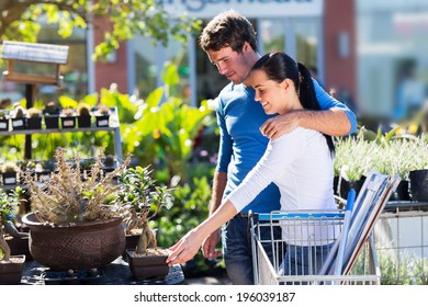 happy young couple shopping for bonsai in nursery - Powered by Shutterstock