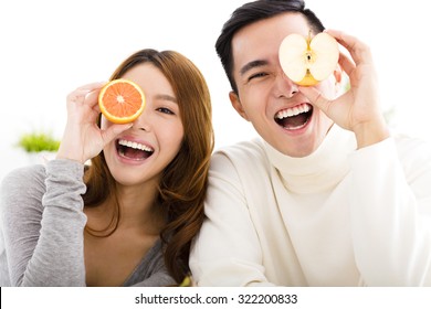 Happy Young Couple Showing Healthy Food 