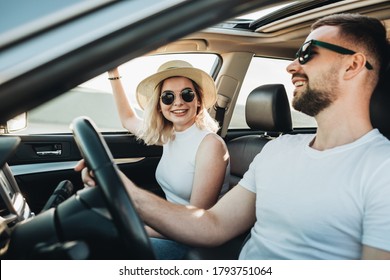 Happy Young Couple Sitting Inside Their Car Enjoying Road Trip, Travel and Adventure Concept - Shutterstock ID 1793751064