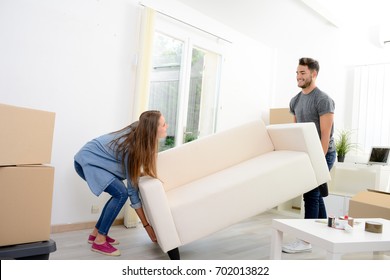 Happy Young Couple Student Roommate Packing Boxes And Moving Furniture During Their Move Into New Home Flat Apartment