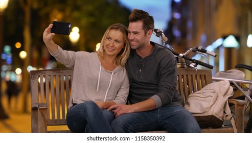 Happy Young Couple Taking A Selfie On The Champs-Elysees At Night