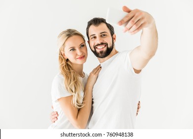 happy young couple taking selfie with smartphone isolated on white - Shutterstock ID 760948138