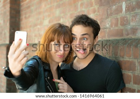 Similar – Young couple posing with funny faces