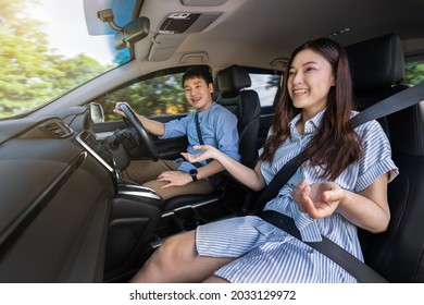 Happy Young Couple Is Talking While Driving A Car