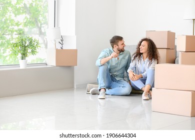 Happy Young Couple In Their New Flat On Moving Day