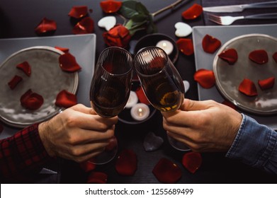 Happy Young Couple Toasting Champagne Glasses Having Romantic Dinner. Top View. Candles, Flowers And Wine. Concept About People, Lifestyle, Love And Romance