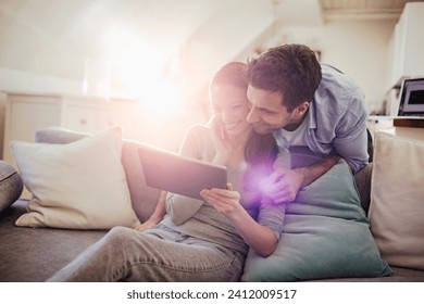 Happy young couple using table on sofa at home - Powered by Shutterstock