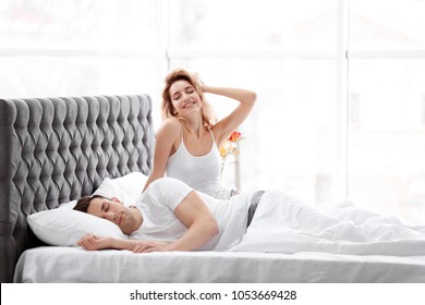 Happy Young Couple Waking Up At Home