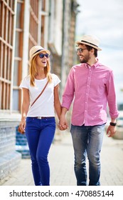 Happy Young Couple Walking In The City