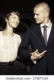 Happy Young Couple Walking On The Night Street