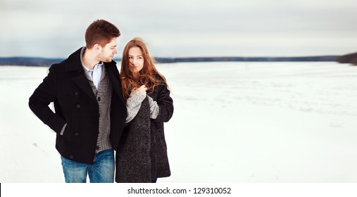 Happy Young Couple In Winter Park Having Fun.Family Outdoors. Love