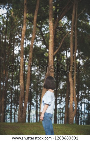 Similar – Image, Stock Photo Low angle view of blonde white girl posing in the forest with trees in the background.