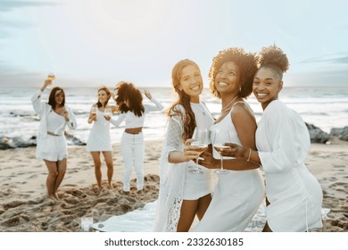 Happy young diverse women posing with wine glasses while dancing and having fun on the beach, celebrating hen party at coastline and enjoying their vacation - Powered by Shutterstock