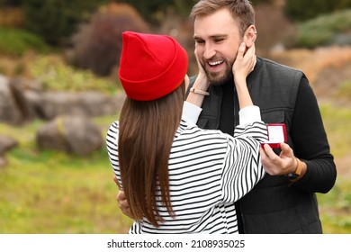 Happy Young Engaged Couple In Beautiful Autumn Park