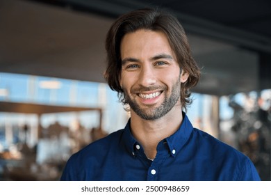 Happy young European professional business man, casual guy looking at camera, headshot close up face portrait. Confident smiling businessman, male entrepreneur, small business owner posing outdoors.