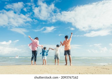 Happy young family Asian have fun on beach. Young family on vacation have a lot of fun - Powered by Shutterstock