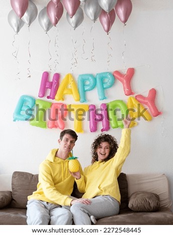 Similar – Young couple celebrating a party with their dog